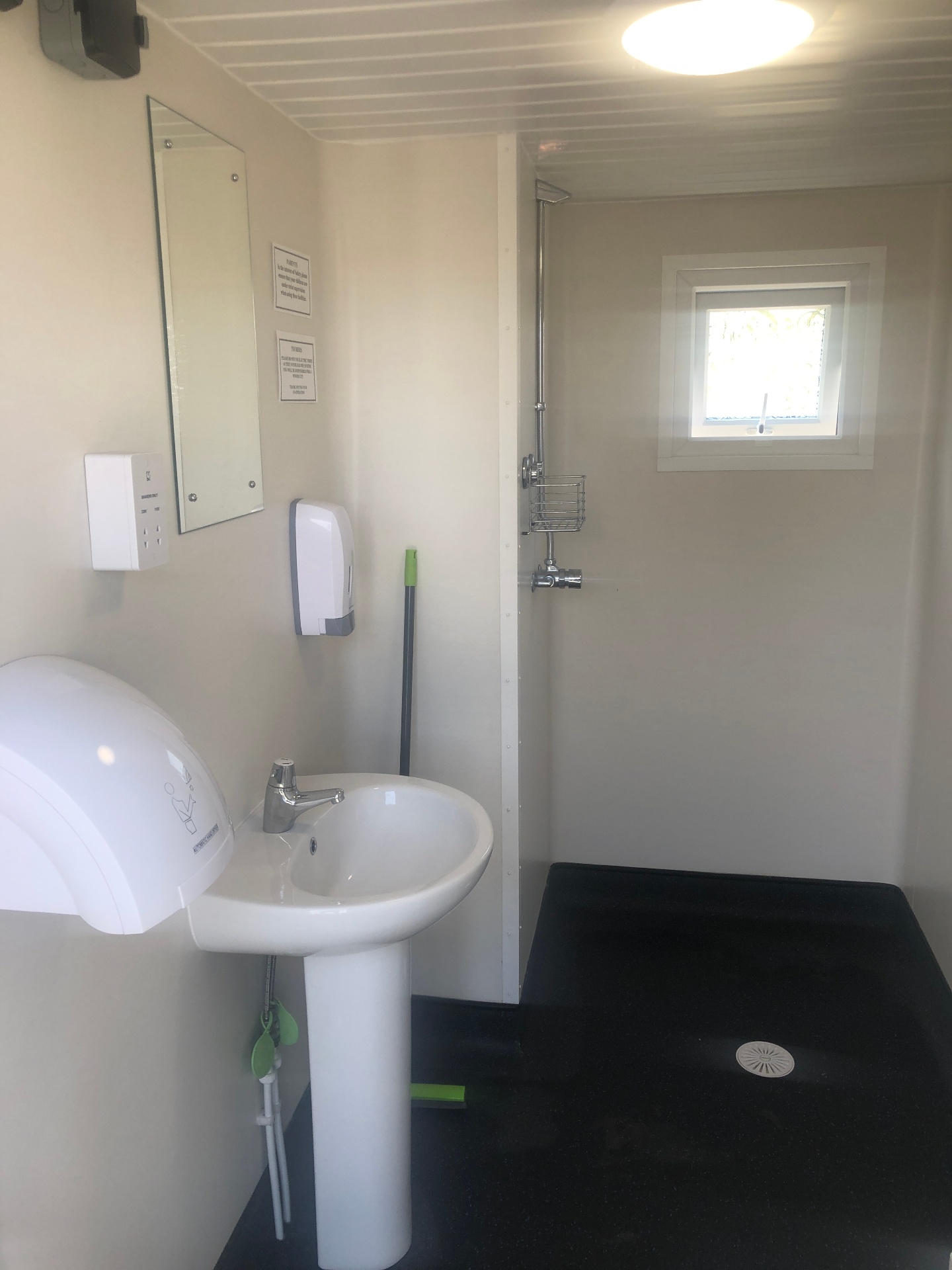 Modern shower and toilet block exterior at Pen Parc Caravan Park